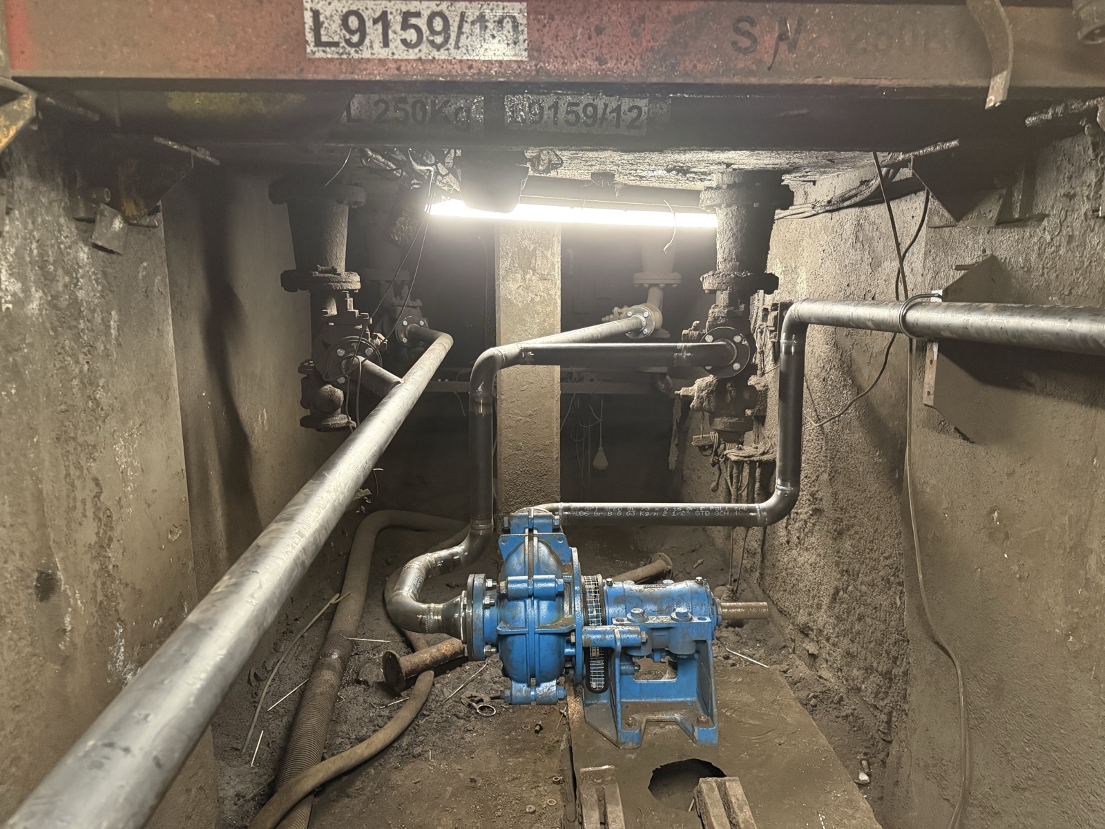New pipework and a blue gearbox pump refitted in the underground service duct on the BOS plant at British Steel
