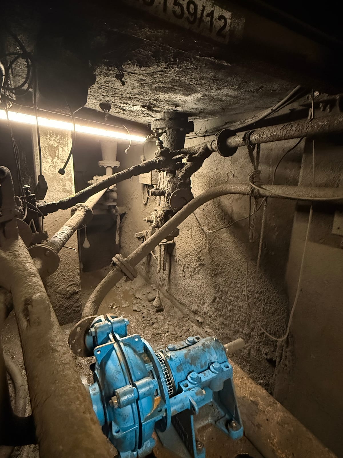 Existing damaged pipework above the pump in the underground chamber before removal