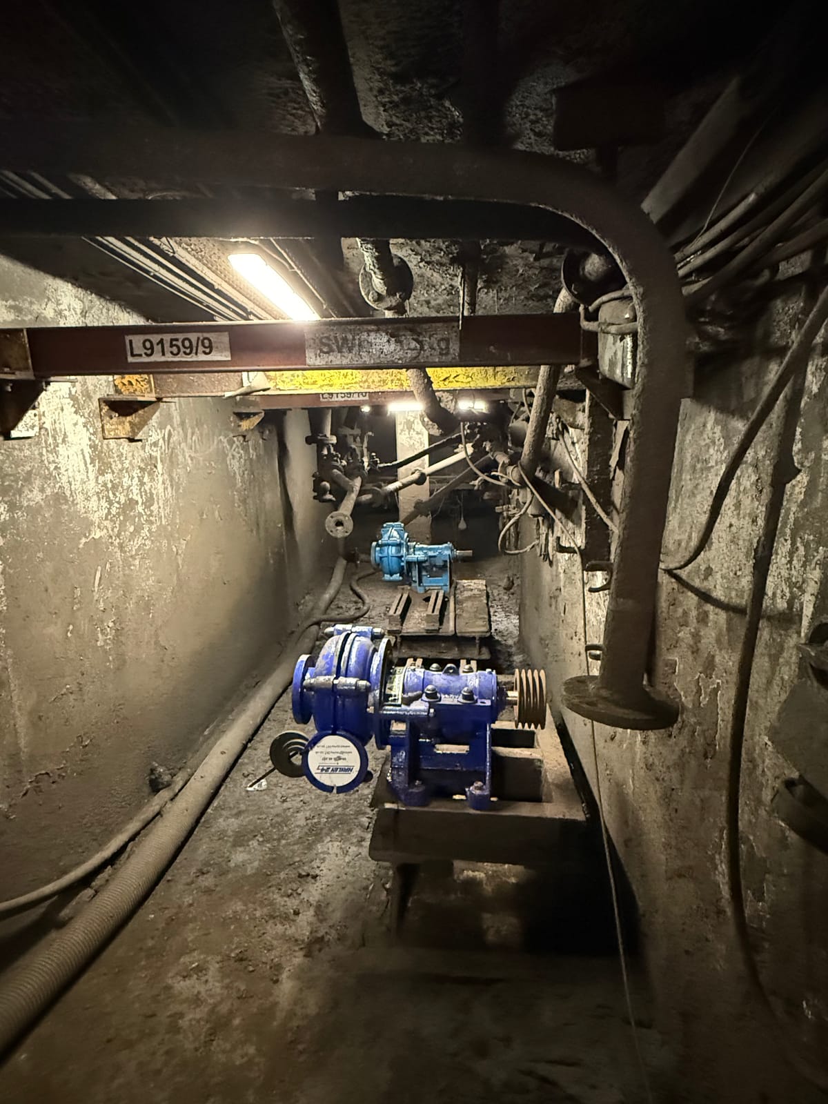 The chamber cleared, with the pump set standing ready under the lifting beam