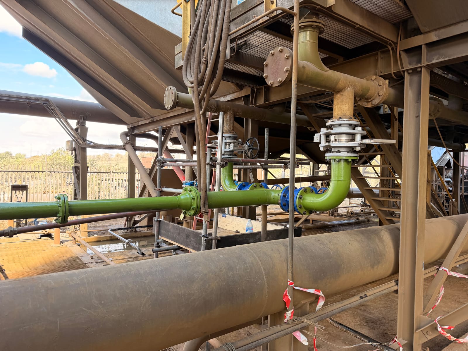 Valve fitted into the green line on the elevated pipework outside