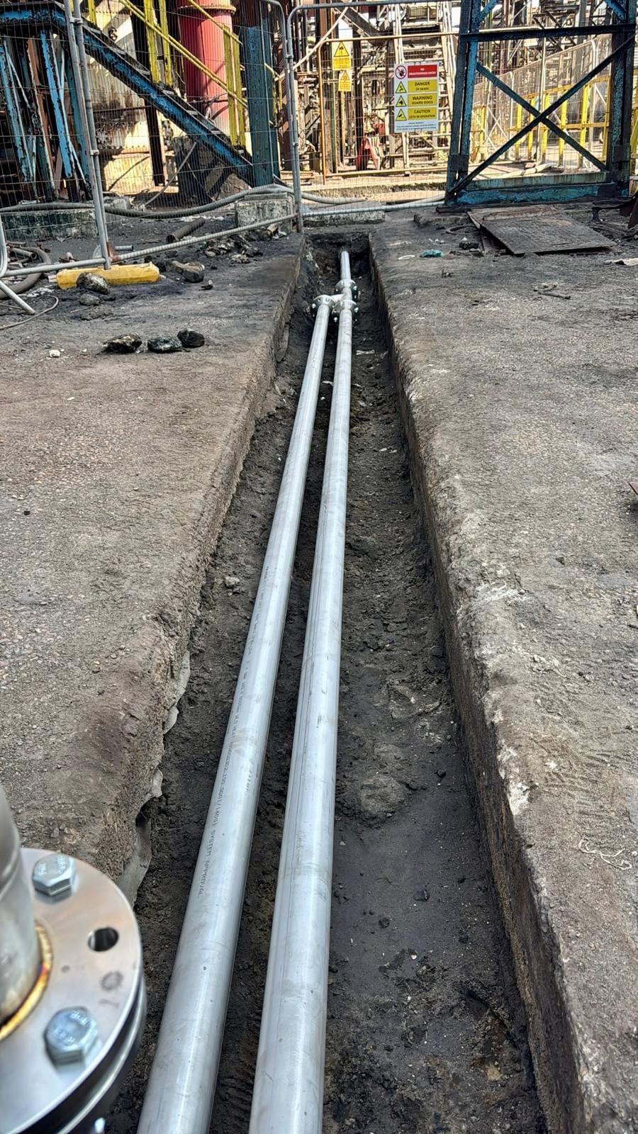 Two runs of new pipework laid the length of the open low level pit