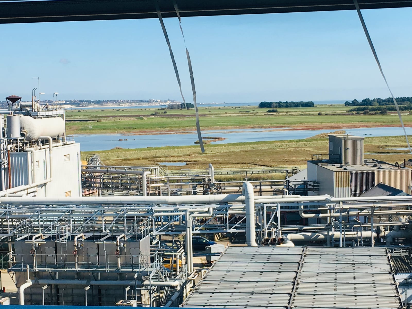 The works at Discovery Park seen from height, with the marshes and the Kent coast behind
