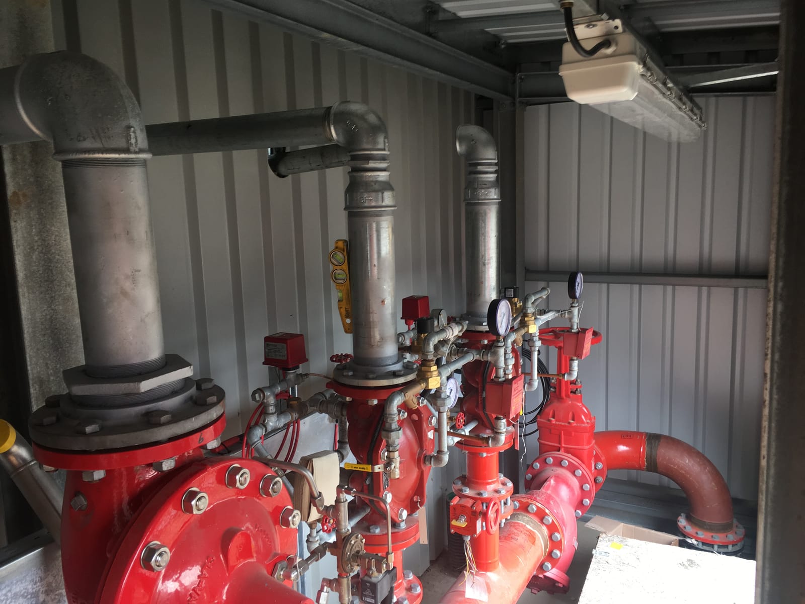 Red deluge valve set and gauges in the plant room