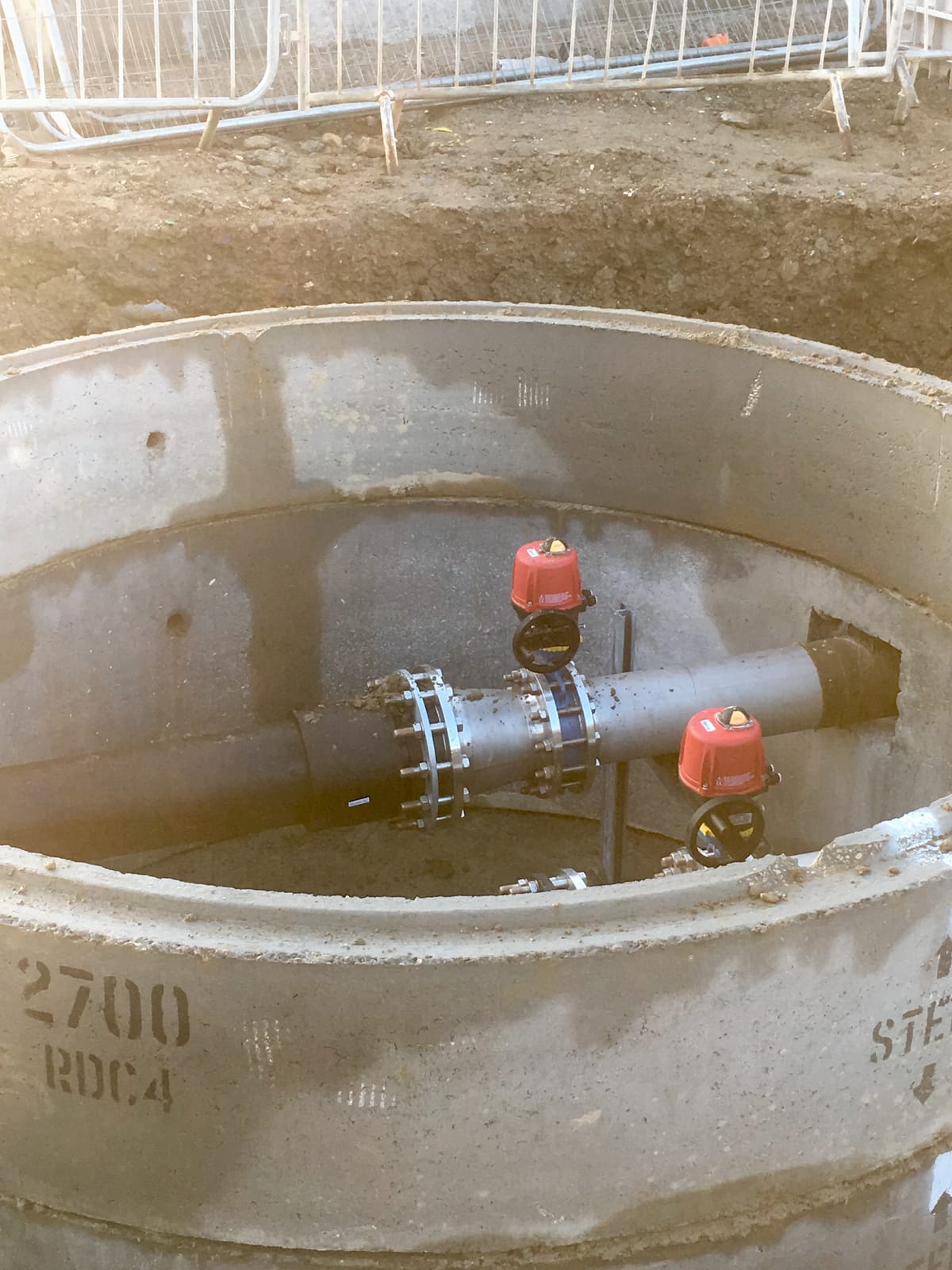 Hydrant pipework and red capped valve in the chamber